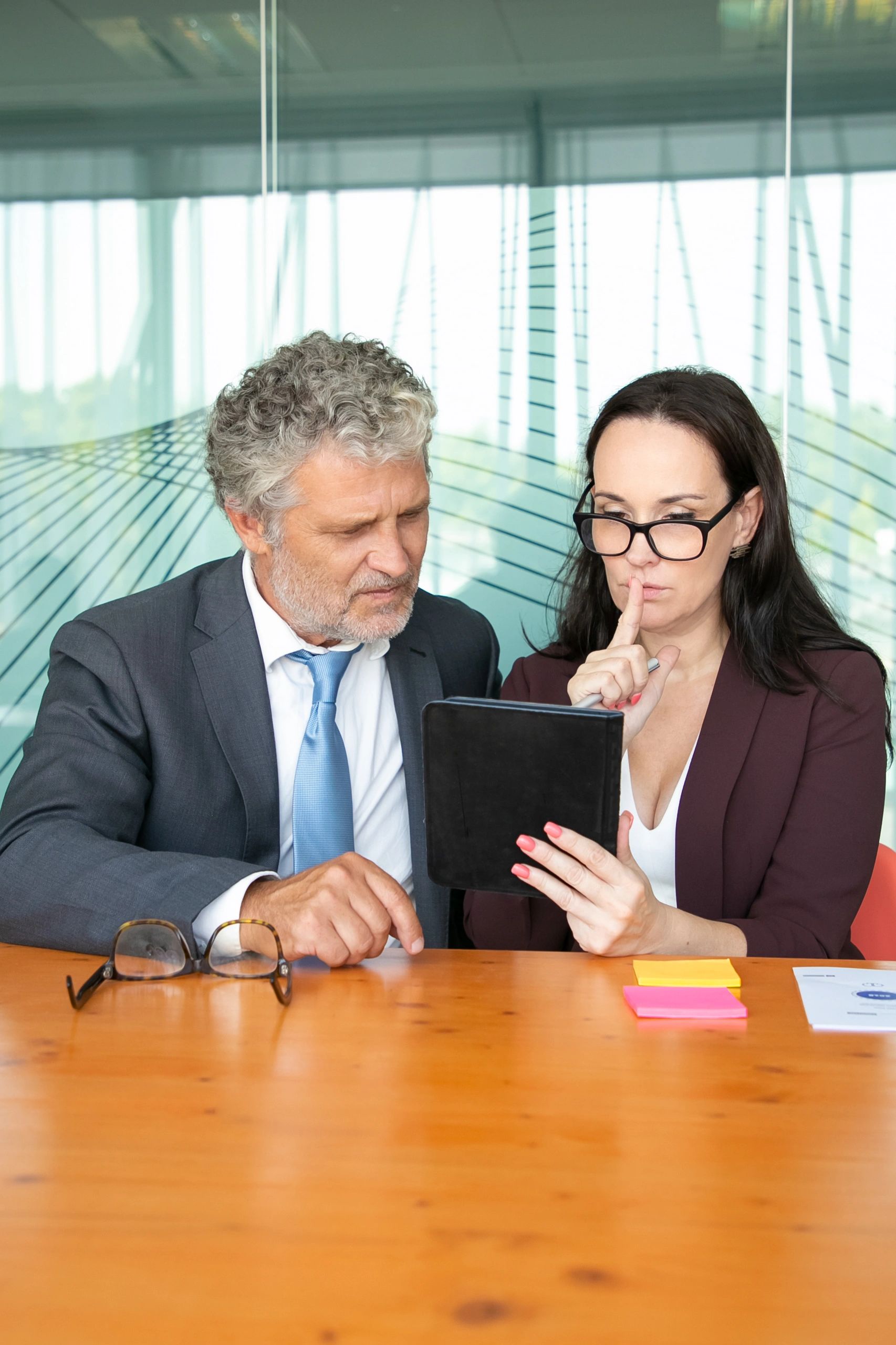 Colleagues reviewing finance information together on a tablet